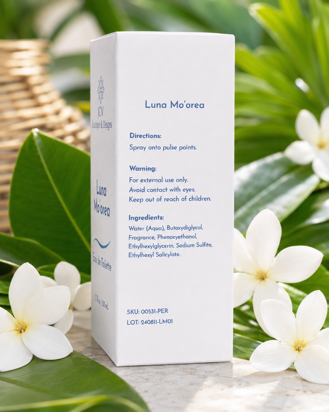 A white rectangular box of Luna Mo'orea facial spray stands upright on a light surface, surrounded by green leaves, white flowers, and a woven basket in the background.