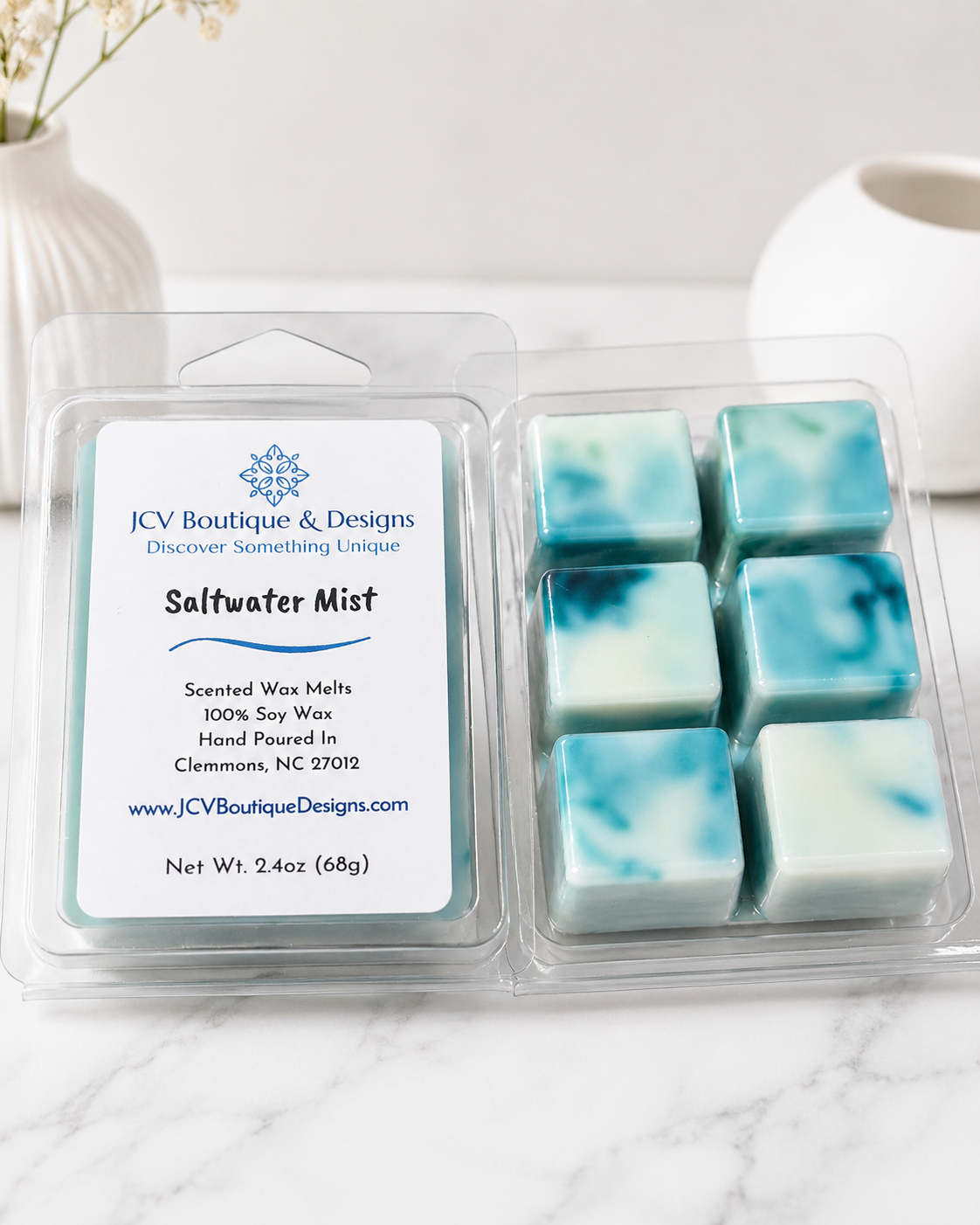 Pack of JCV Boutique & Designs Saltwater Mist scented wax melts on a marble surface.