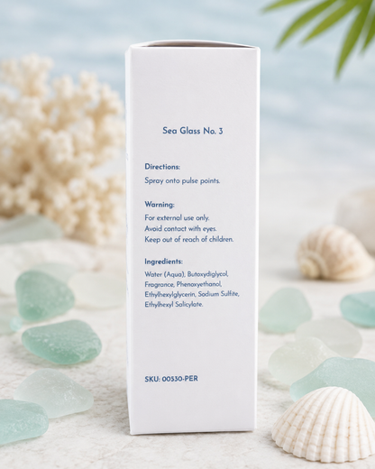 A tall white product box labeled 'Sea Glass No. 3' stands upright on a light surface with seashells and sea glass around it.